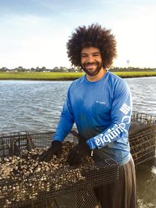 Self-Help borrower Ryan Bethea Ryan Bethea, oyster farmer and owner of Oysters Carolina, posing with some oysters