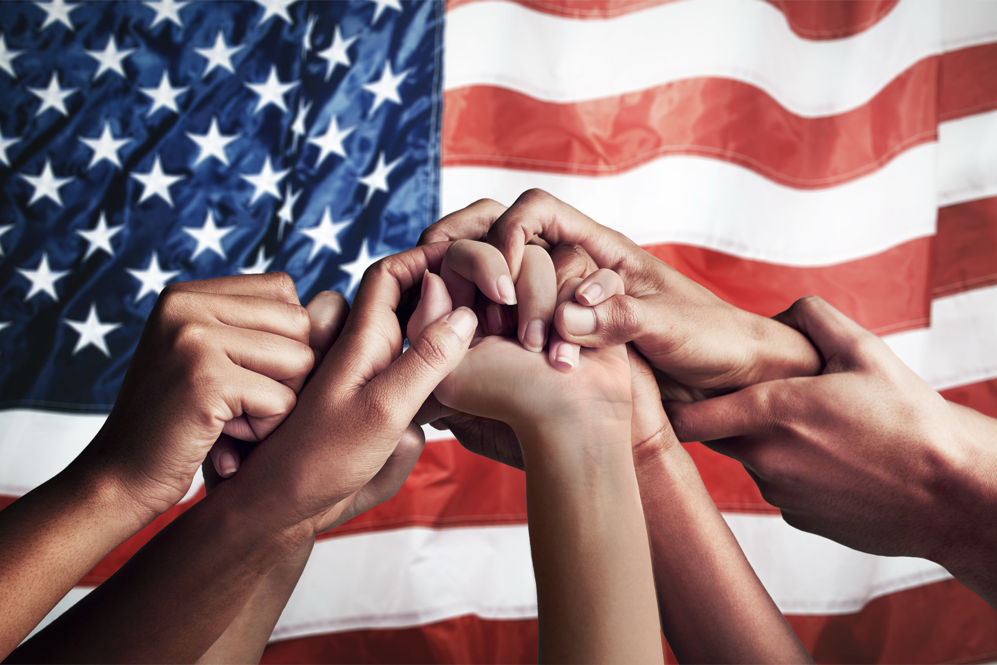 Collaboration, unity and hands holding in front of American flag