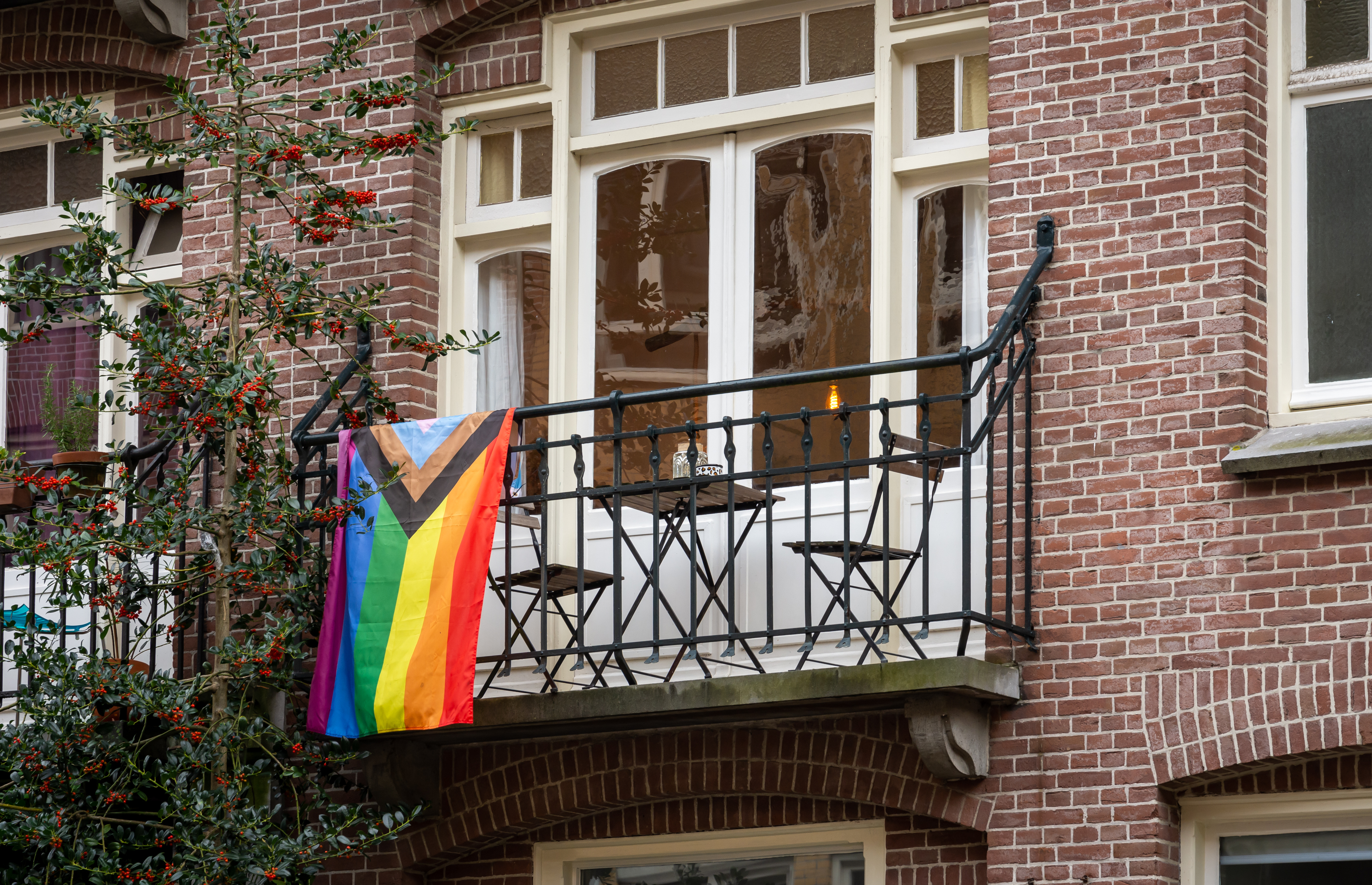 pride flag hanging outside a home