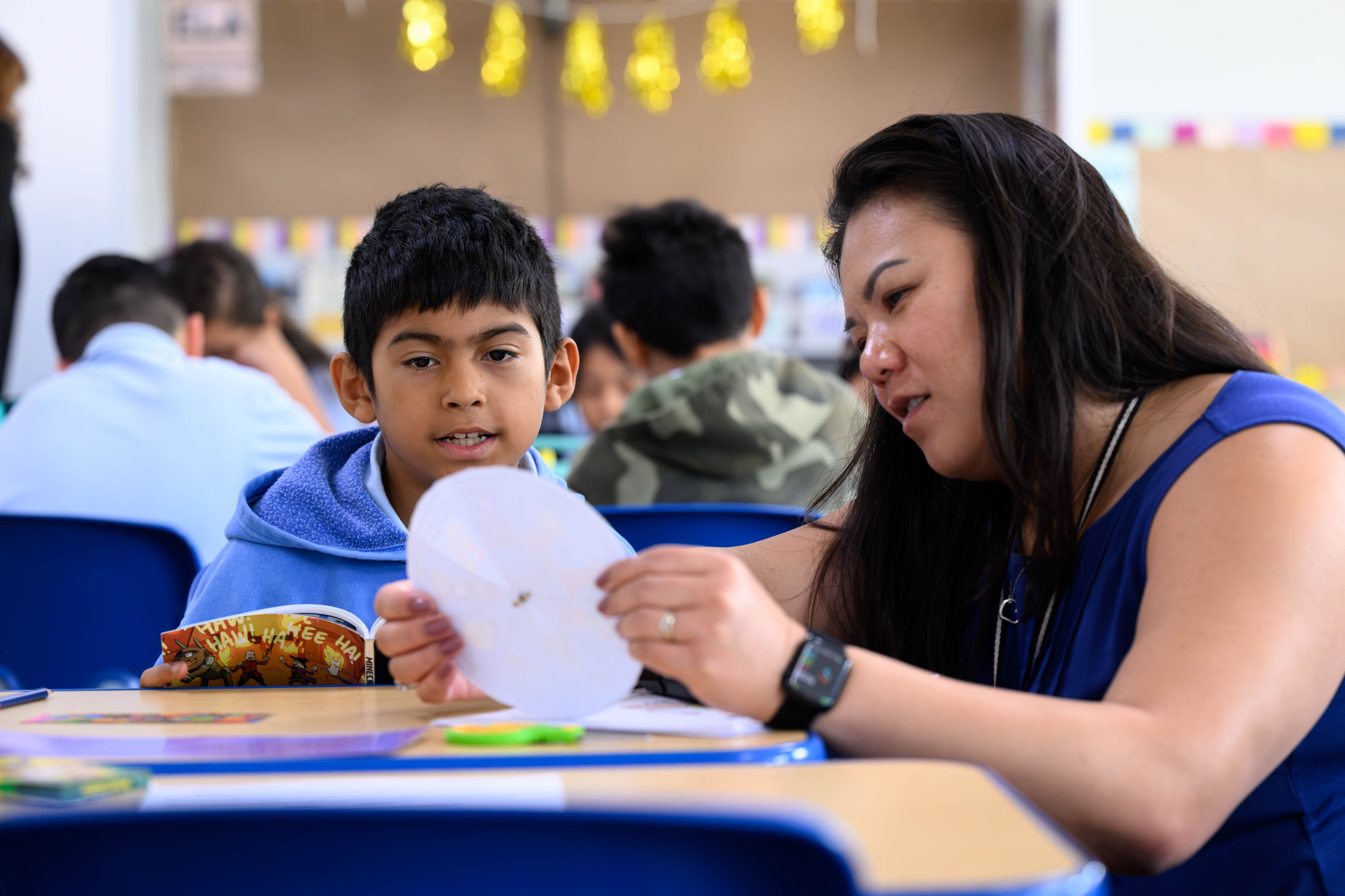 Valor Academy Elementary School principal May Oey checks in with student Nahum during a social-emotional learning activity.