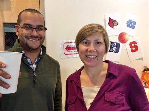 Two Self-Help staff members attending an ACC Basketball viewing.